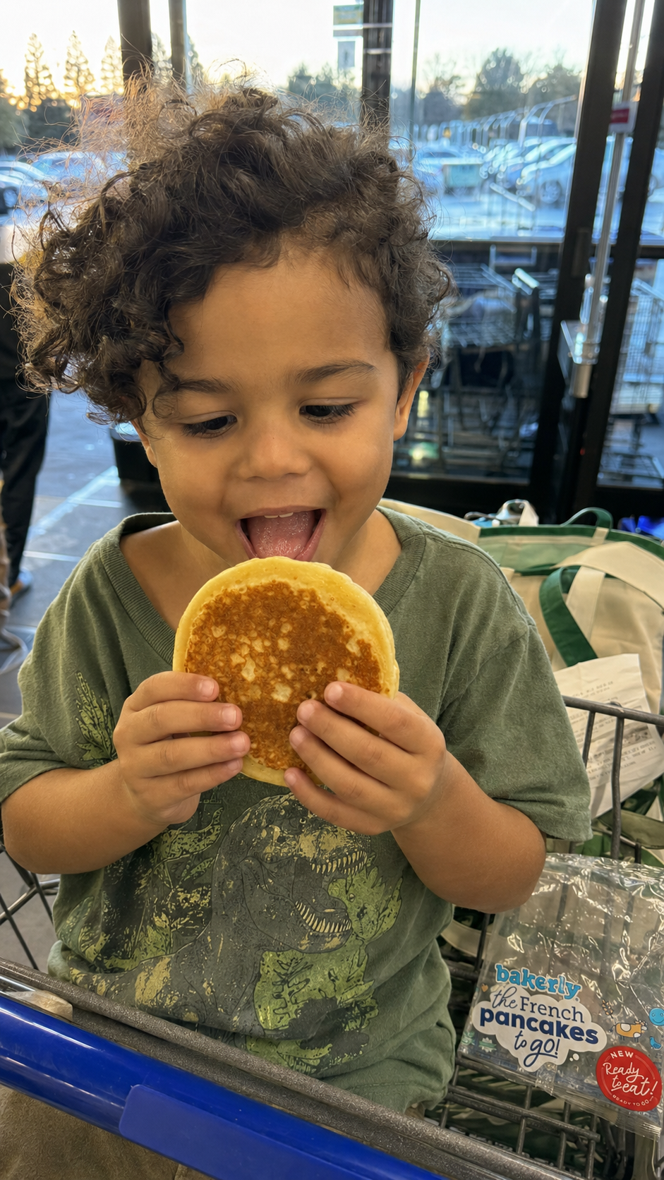 Child enjoying a bakerly French pancake during a shopping trip