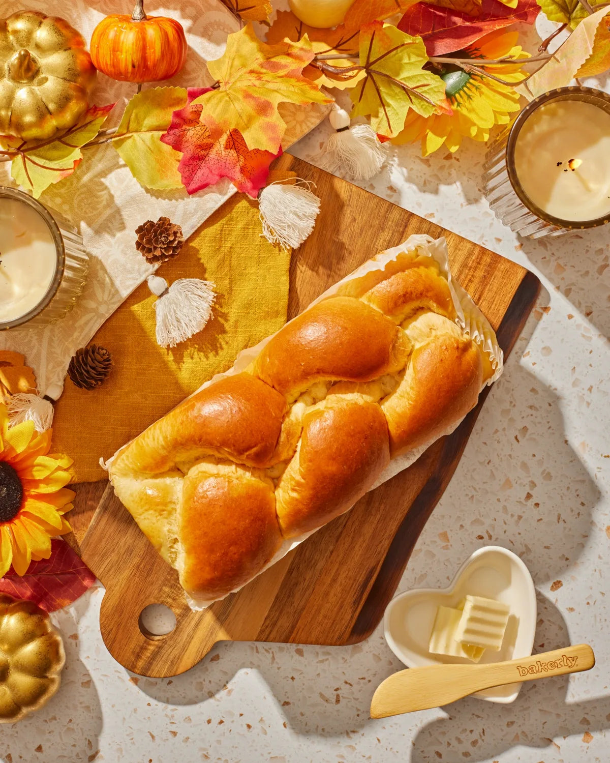 Hand braided brioche styled with warm fall accents
